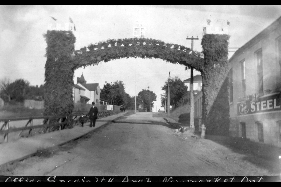 The Office Specialty Arch in Newmarket, Ontario — a foliage-covered arch over the street.